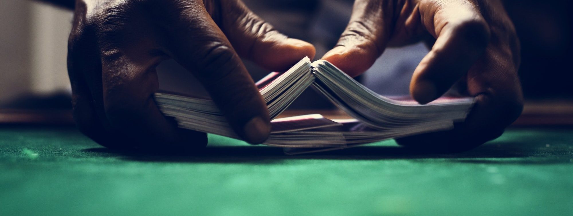 Dealer shuffling a deck of cards in casino