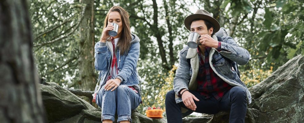 Backpackers drinking coffee or tea during hiking